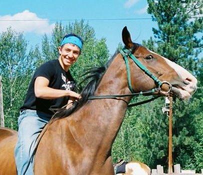 Jake as a teenager and his Omak Stampede horse, Eagle Boy, the first horse that he ran down the hill (Courtesy of Kassie Guglielmino)